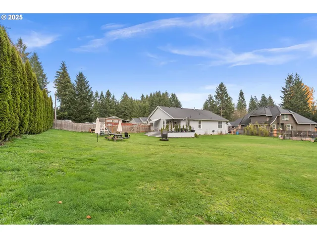 a view of a big yard with a house in the background
