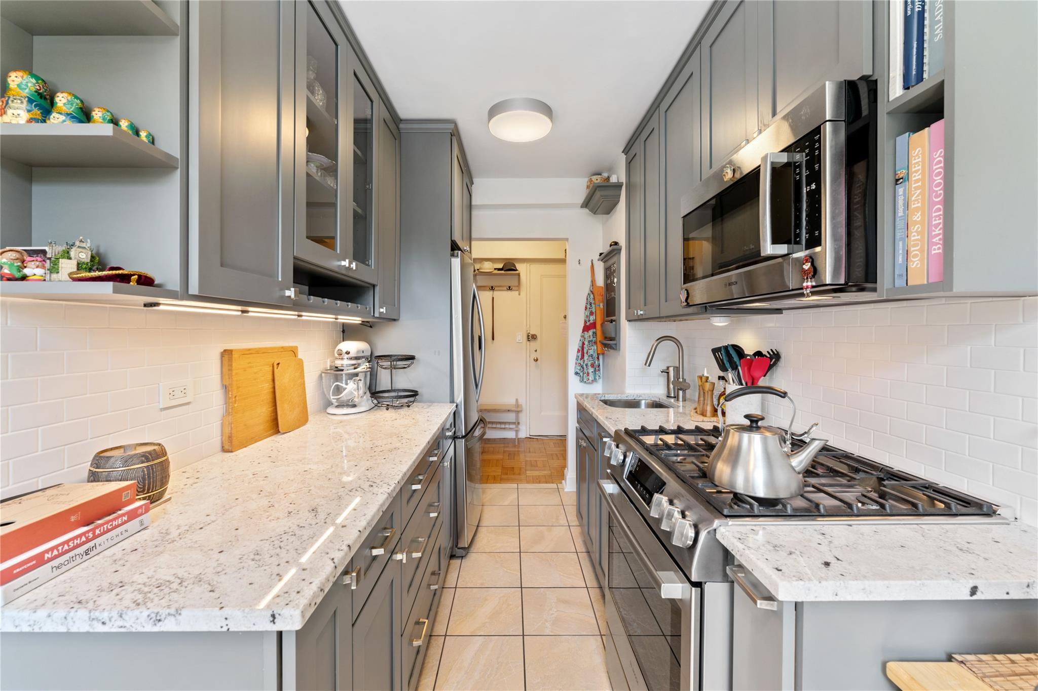 3103 Fairfield Avenue, Unit 5D Bronx, NY 10463 - Photo 4 of 13 a kitchen with stainless steel appliances granite countertop a sink stove and refrigerator