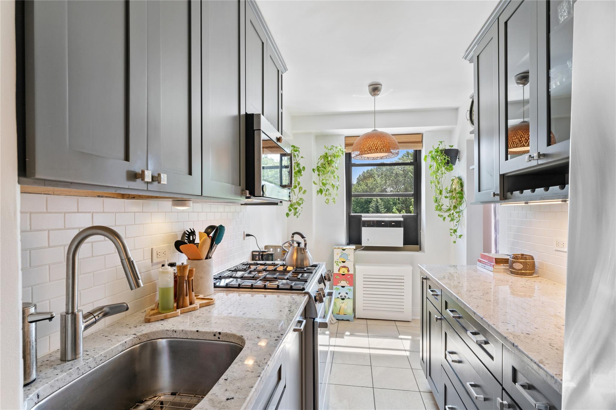 3103 Fairfield Avenue, Unit 5D Bronx, NY 10463 - Photo 5 of 13 a kitchen with granite countertop a sink and a stove top oven