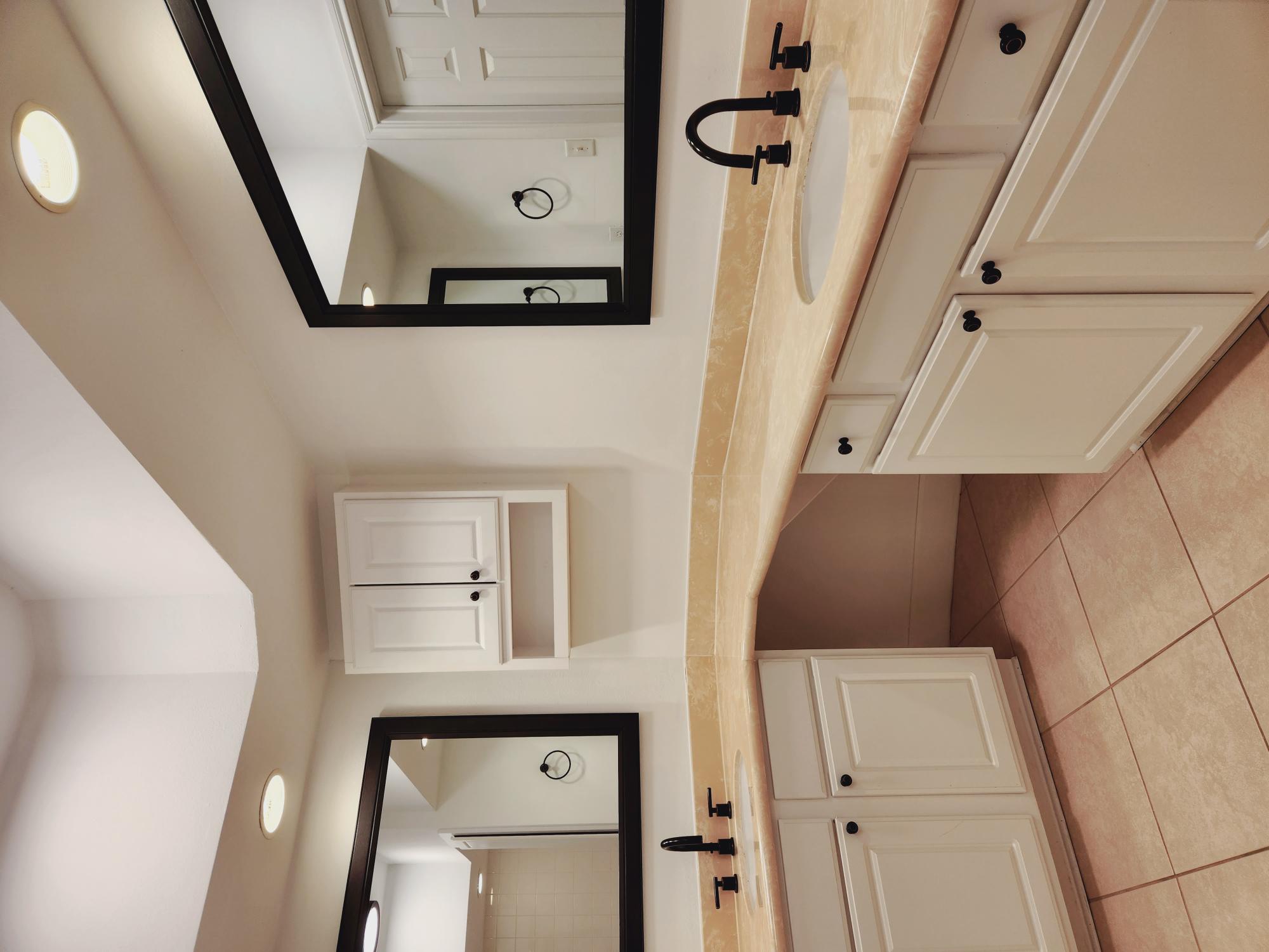 7701 Rialto Boulevard, Unit 833 Austin, TX 78735 - Photo 13 of 24 a bathroom with a sink and a mirror