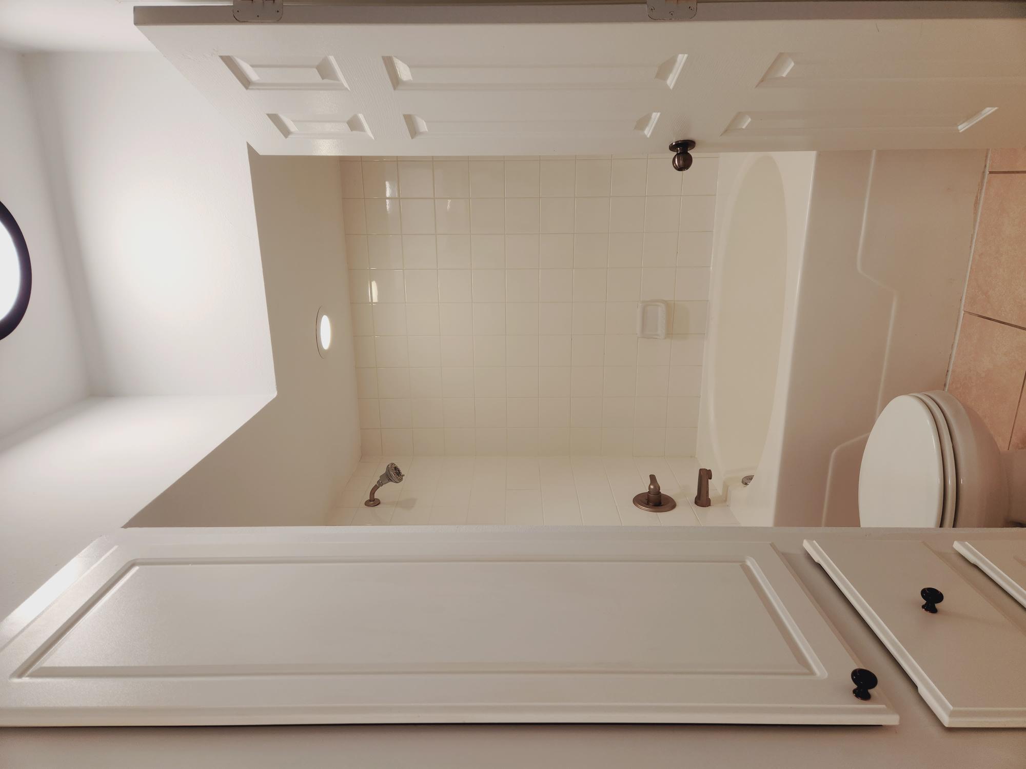 7701 Rialto Boulevard, Unit 833 Austin, TX 78735 - Photo 14 of 24 a bathroom with a bathtub shower and toilet