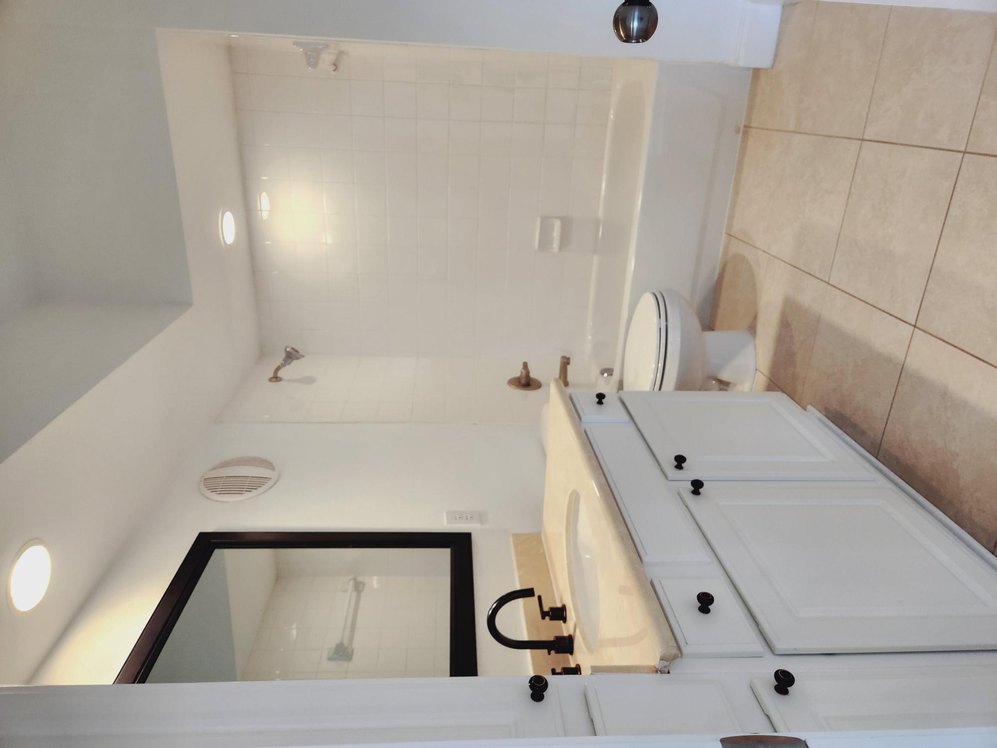 7701 Rialto Boulevard, Unit 833 Austin, TX 78735 - Photo 20 of 24 a bathroom with a tub sink toilet and mirror