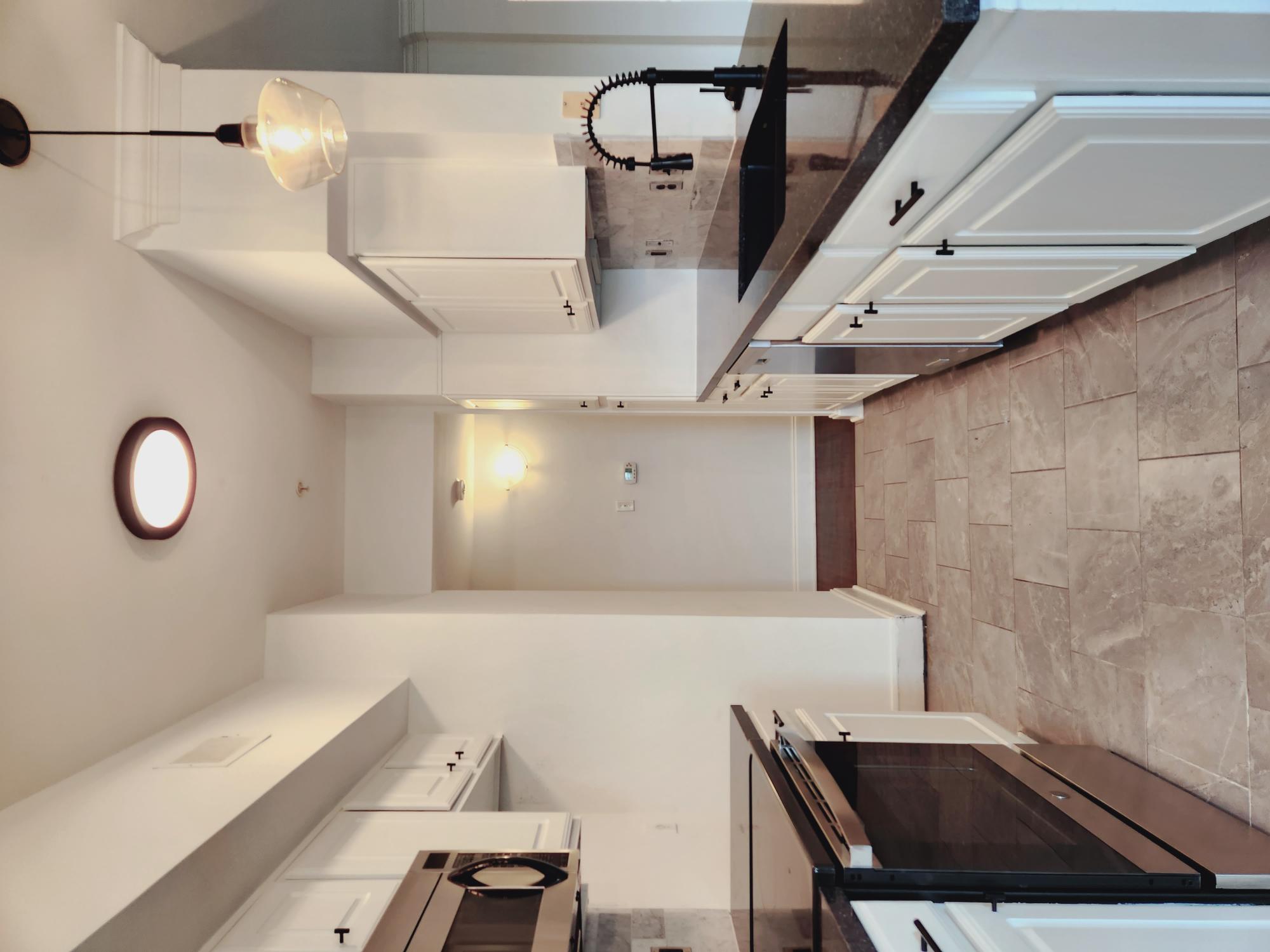 7701 Rialto Boulevard, Unit 833 Austin, TX 78735 - Photo 7 of 24 a kitchen with granite countertop a stove a sink and a refrigerator