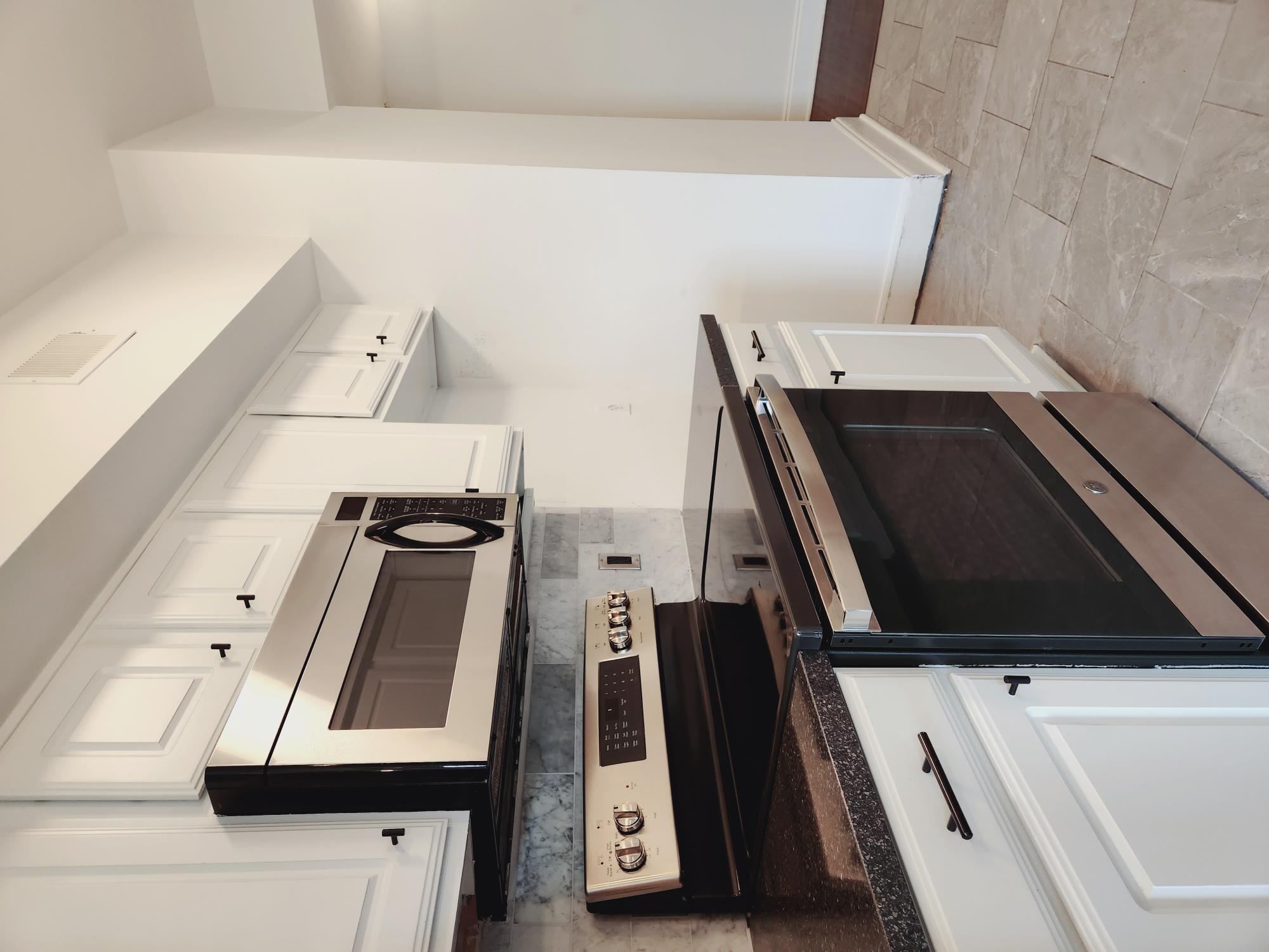 7701 Rialto Boulevard, Unit 833 Austin, TX 78735 - Photo 8 of 24 a kitchen with stainless steel appliances granite countertop white cabinets and stove