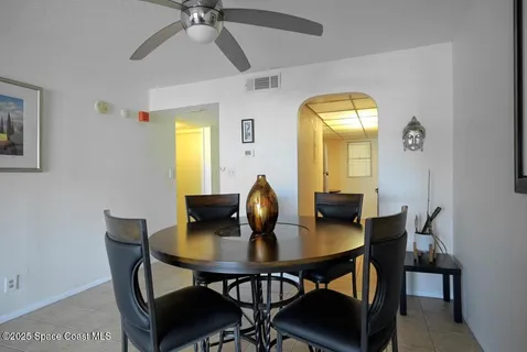 a view of a dining room with a table and chairs