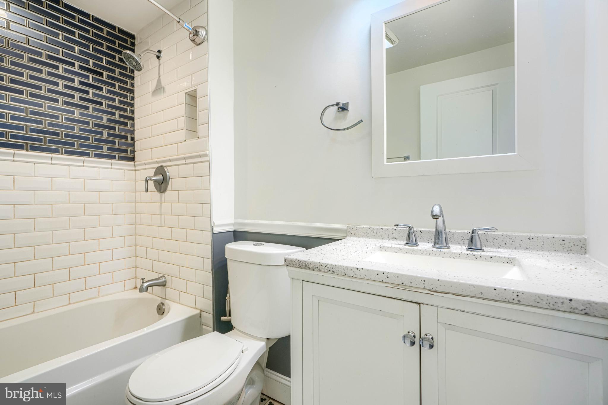 3533 Keswick Road Baltimore, MD 21211 - Photo 22 of 29 Modern bathroom with stylish tile accents.