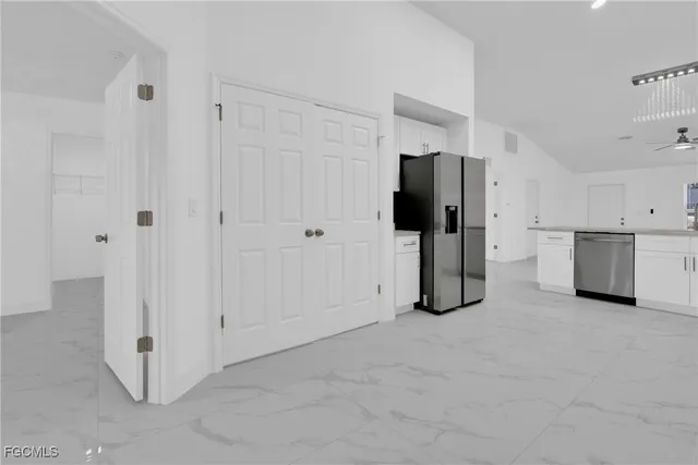 a view of kitchen with refrigerator sink and stove