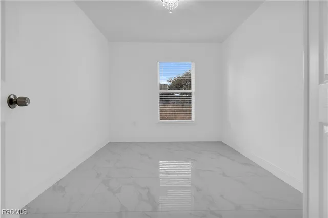 an aerial view of a residential apartment building with a yard and parking spaces