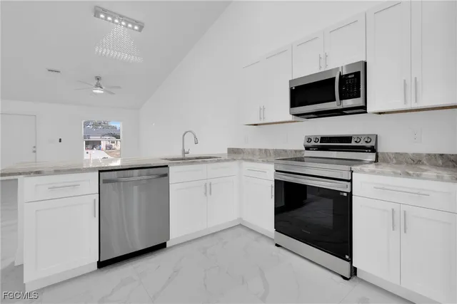 a bedroom with bed and a chandelier