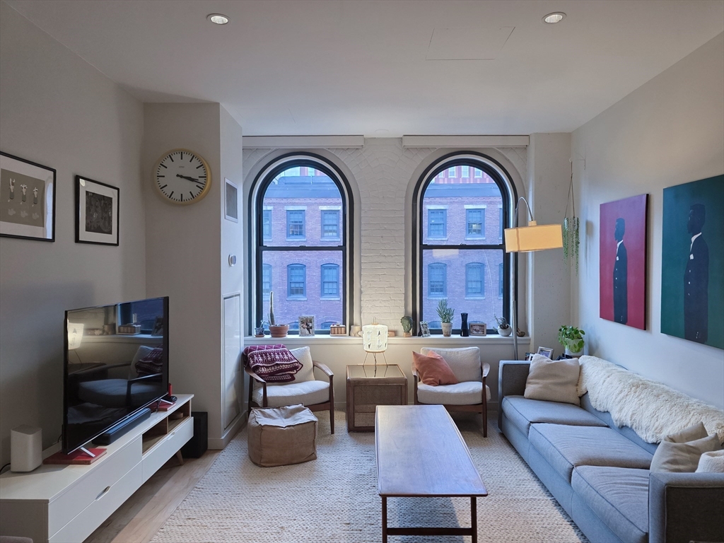 346-354 Congress Street, Unit 505 Boston, MA 02210 - Photo 1 of 14 a living room with furniture and a flat screen tv
