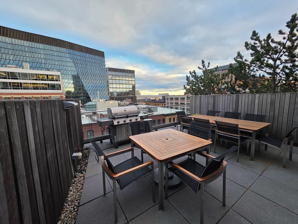 346-354 Congress Street, Unit 505 Boston, MA 02210 - Photo 12 of 14 a backyard of a house with barbeque oven table and chairs