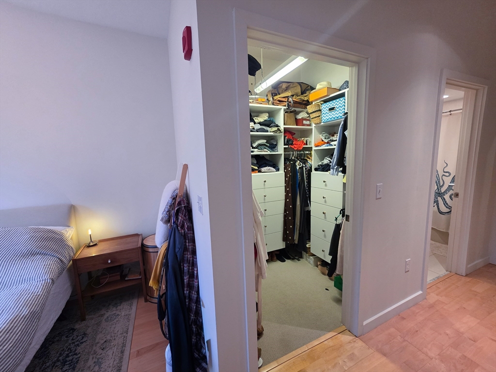 346-354 Congress Street, Unit 505 Boston, MA 02210 - Photo 7 of 14 a view of a bedroom with hallway and a couch