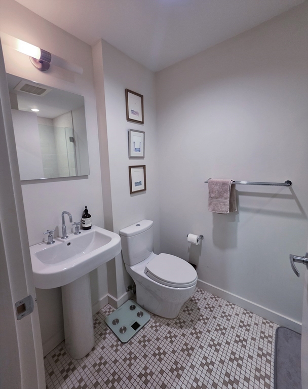 346-354 Congress Street, Unit 505 Boston, MA 02210 - Photo 10 of 14 a bathroom with a sink toilet and mirror