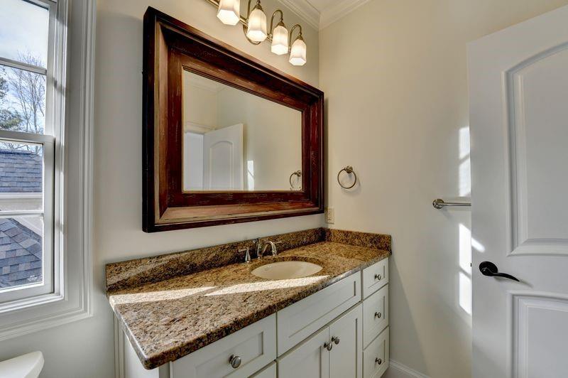 4045 Ridge Road Buford, GA 30519 - Photo 57 of 97 a bathroom with a granite countertop sink and a mirror