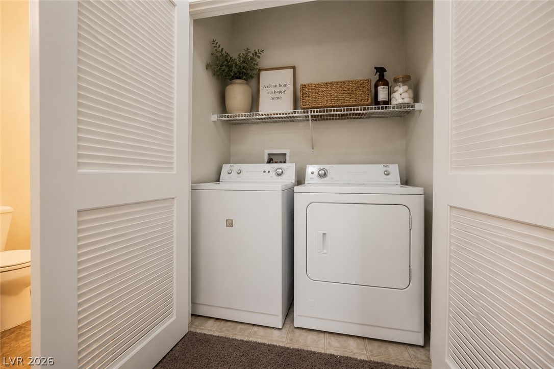 6320 Snap Ridge Street, Unit 201 North Las Vegas, NV 89081 - Photo 14 of 56 A dedicated space for home essentials, this compact laundry area includes shelving for organization.