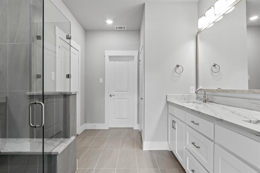 8517 Del Rio Trail Wylie, TX 75098 - Photo 16 of 30 a spacious bathroom with a double vanity sink mirror and double