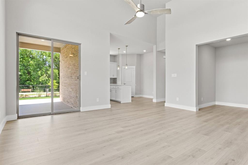 8517 Del Rio Trail Wylie, TX 75098 - Photo 8 of 30 an empty room with wooden floor and windows