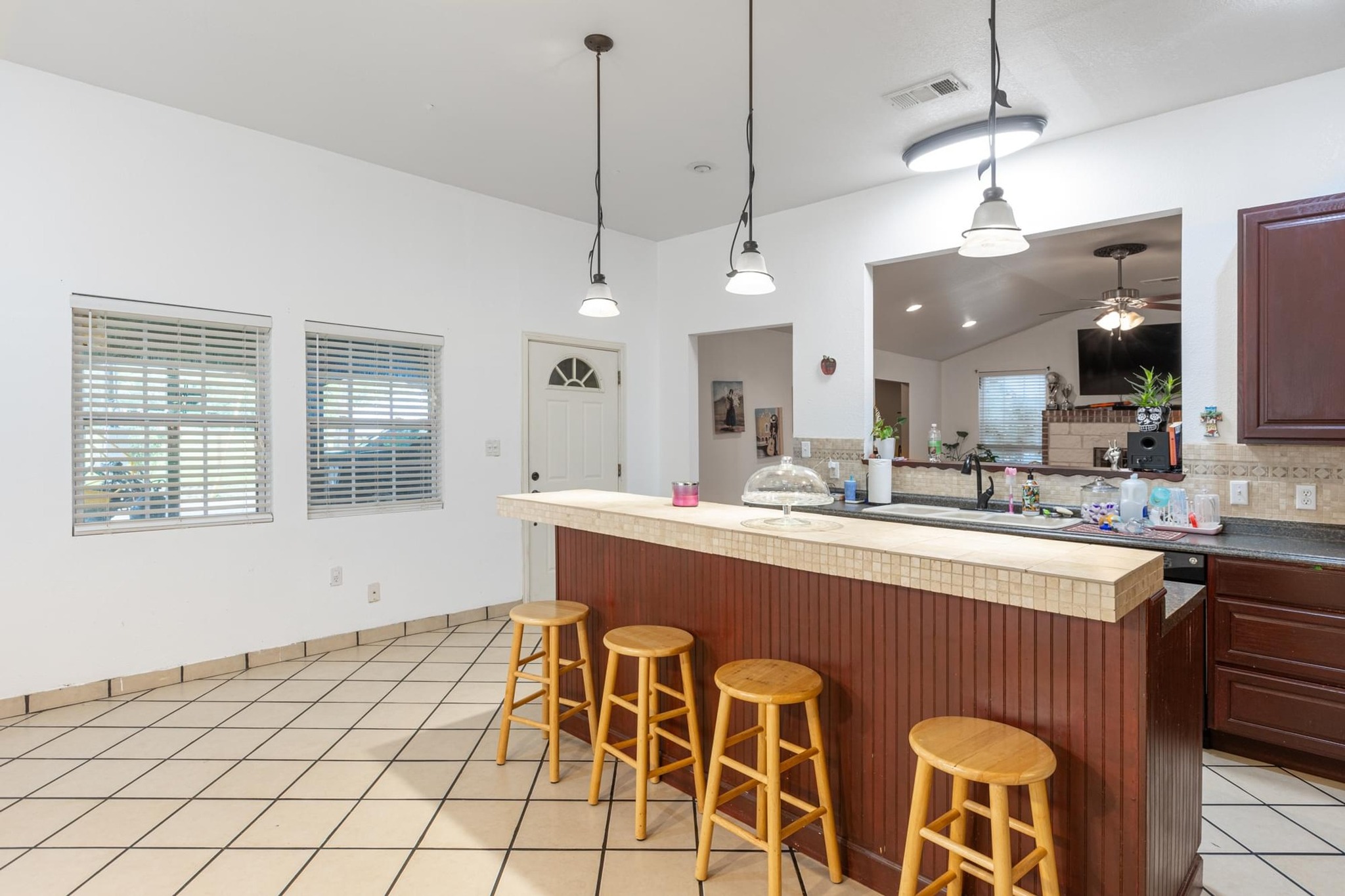 176 Old Lexington Road, Unit C Elgin, TX 78621 - Photo 14 of 31 a kitchen with stainless steel appliances granite countertop a sink a stove a dining table and chairs