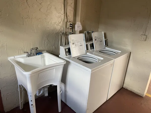 a bathroom with a sink mirror and toilet