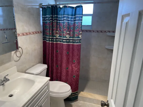 a bathroom with a shower and a window