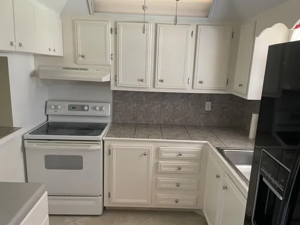 a kitchen with a sink and washing machine