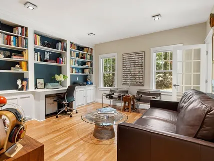 a living room with furniture and a book shelf