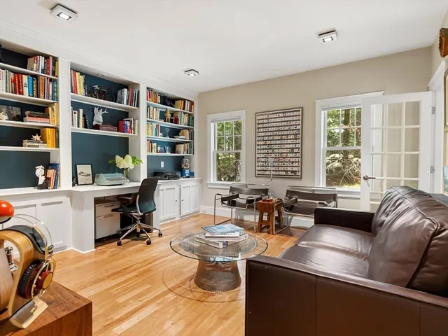 a living room with furniture and a book shelf