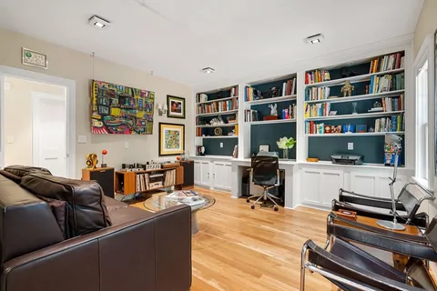 a living room with furniture and a bookshelf