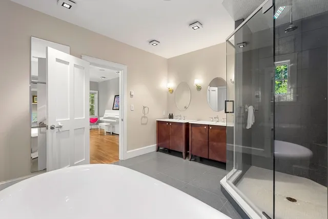 a bathroom with a tub shower and sink