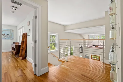 a view of a living room with hardwood floor and a large window