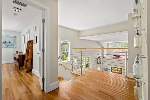 a view of a living room with hardwood floor and a large window
