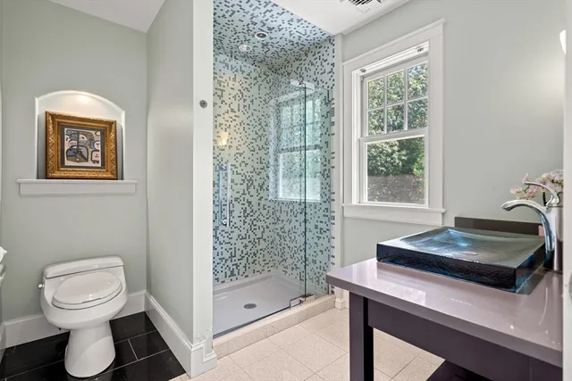 a bathroom with a sink toilet and shower