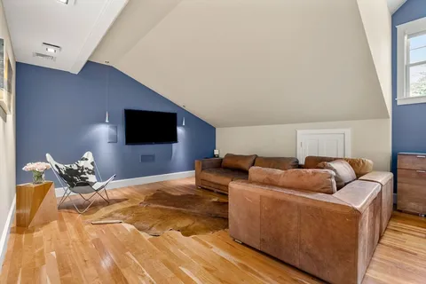 a bedroom with furniture and a flat screen tv