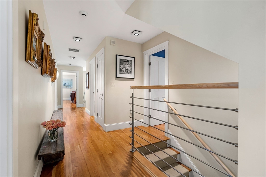 6 Beaver Pond Road Beverly, MA 01915 - Photo 31 of 36 a view of a hallway with wooden floor and a rug