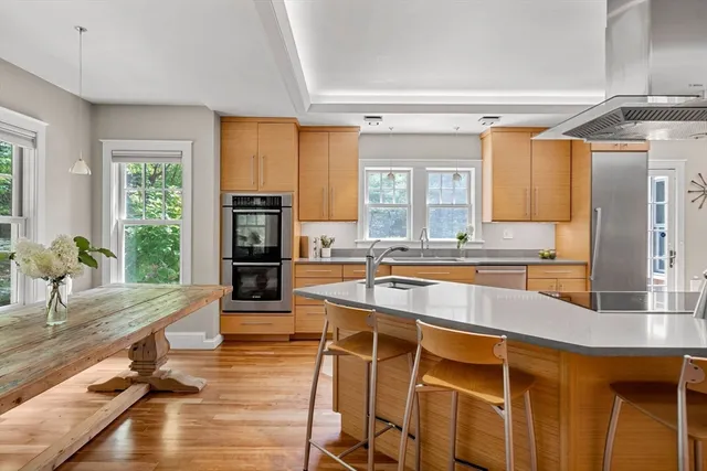 a large kitchen with kitchen island a large counter top space appliances and cabinets