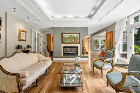 a living room with furniture fireplace and wooden floor