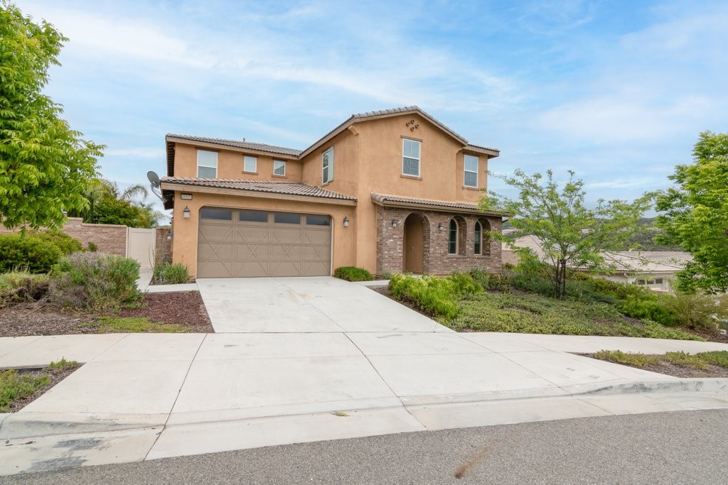 a front view of a house with a yard and a garage