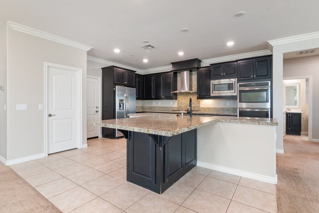 45522 Zander Court Temecula, CA 92592 - Photo 12 of 58 a kitchen with kitchen island cabinets and counter space