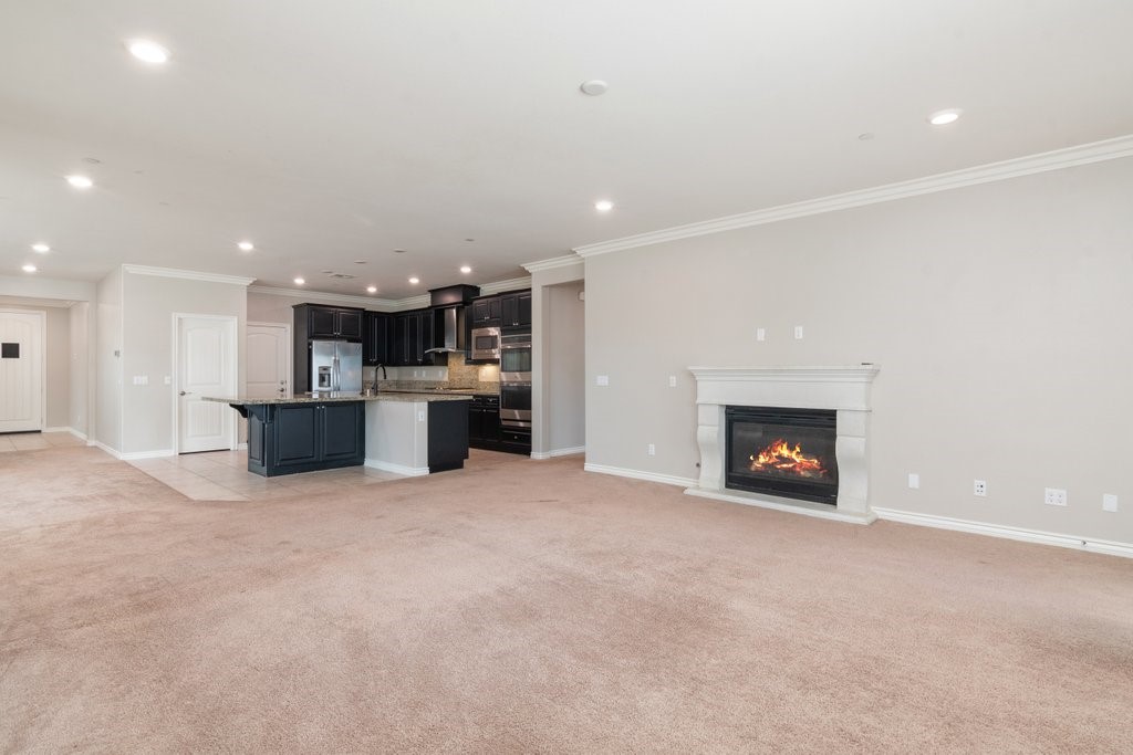 45522 Zander Court Temecula, CA 92592 - Photo 18 of 58 an empty room with kitchen and a fireplace