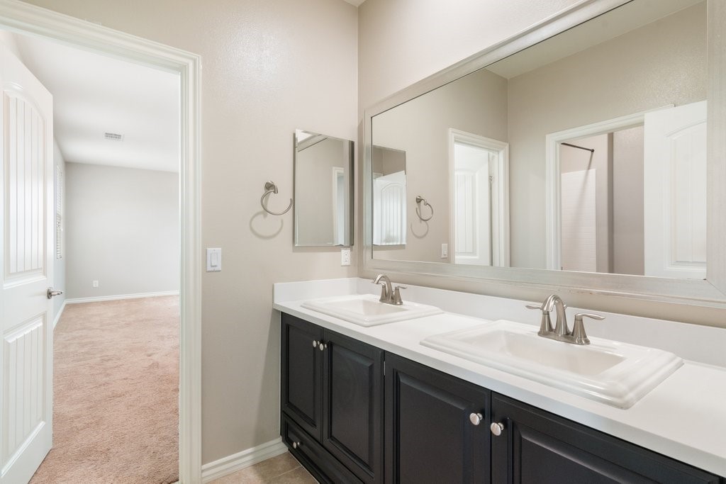 45522 Zander Court Temecula, CA 92592 - Photo 24 of 58 a bathroom with a double vanity sink and a mirror