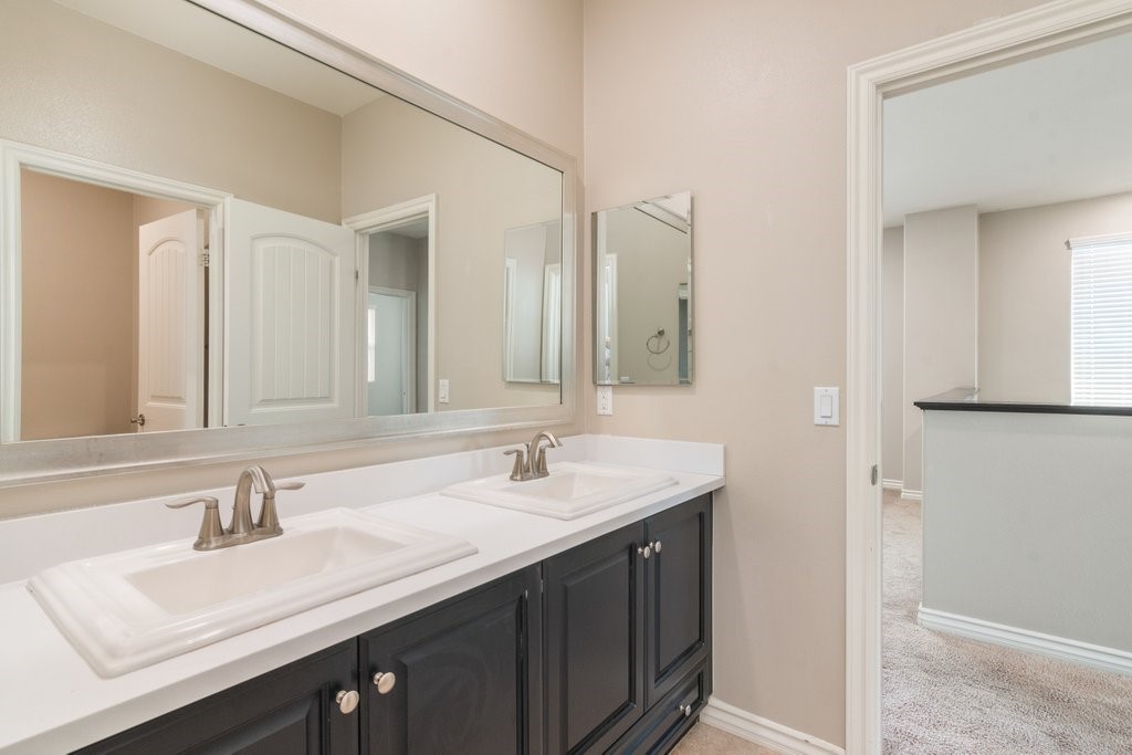 45522 Zander Court Temecula, CA 92592 - Photo 39 of 58 a bathroom with a sink double vanity and a mirror