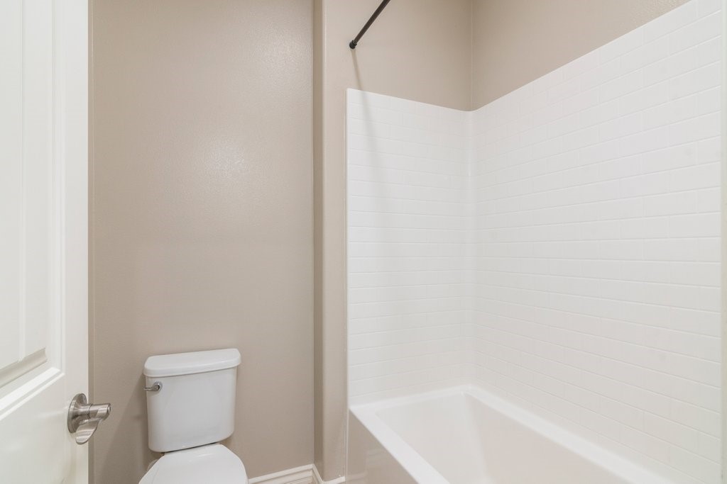 45522 Zander Court Temecula, CA 92592 - Photo 40 of 58 a white toilet sitting next to a bath tub
