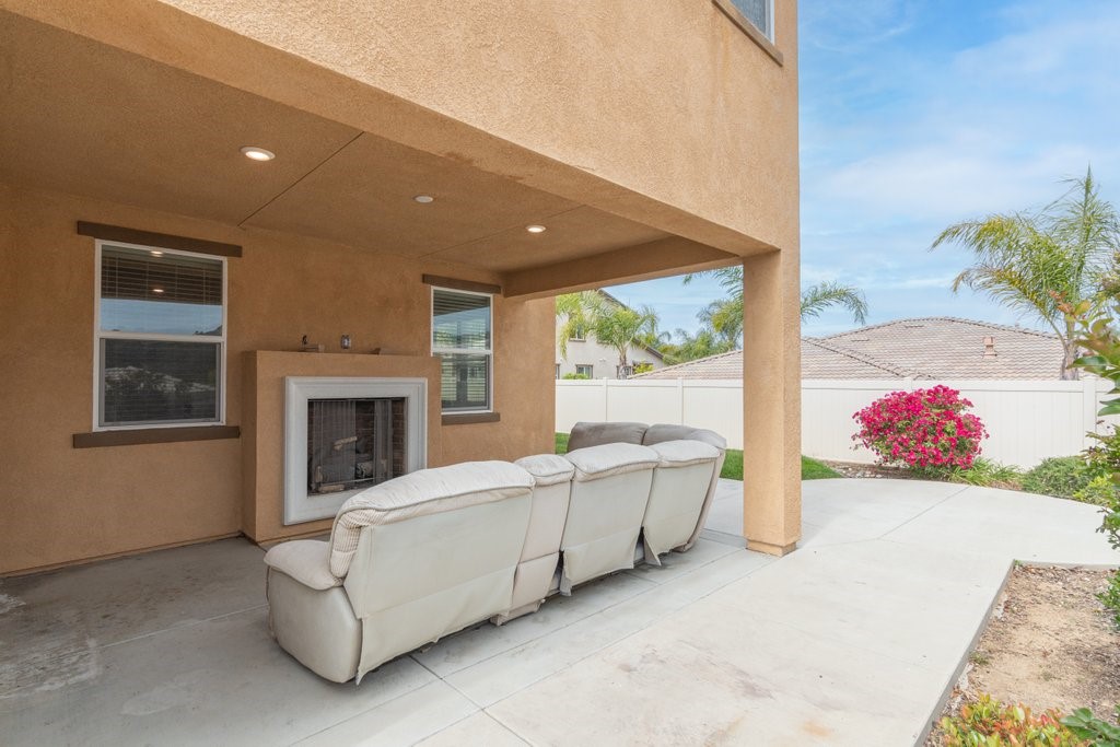 45522 Zander Court Temecula, CA 92592 - Photo 42 of 58 a living room with furniture and a fireplace
