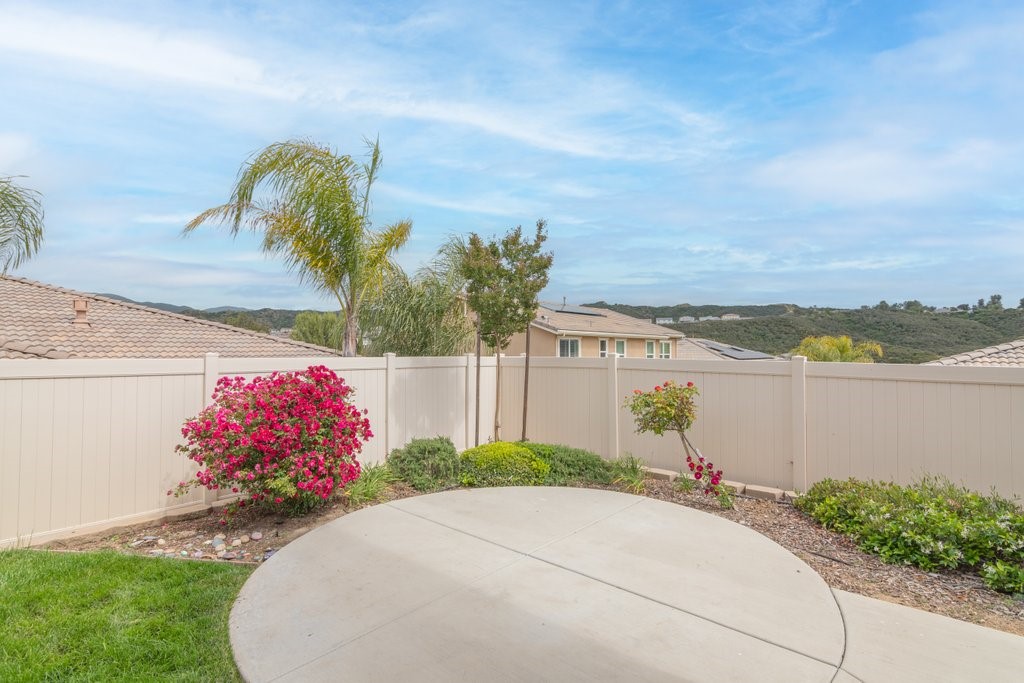45522 Zander Court Temecula, CA 92592 - Photo 43 of 58 a front view of a house with a yard and lake view