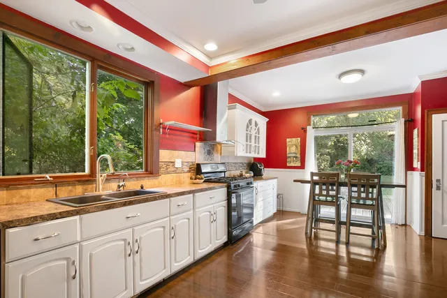 a kitchen with lots of counter top space and wooden floor