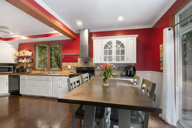 a large kitchen with sink a window and dining table