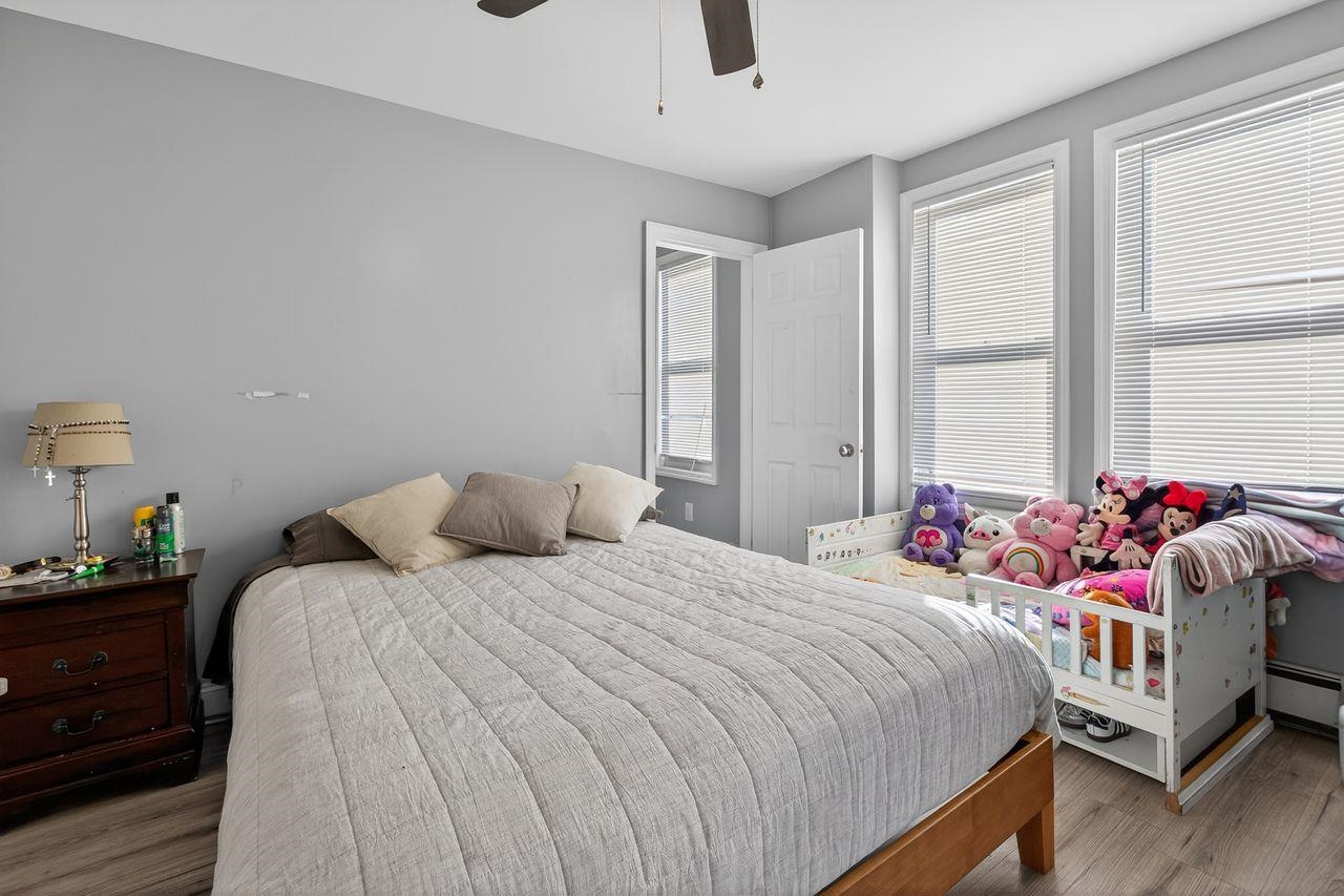 229 Patterson Street Harrison, NJ 07029 - Photo 19 of 26 a bedroom with bed and a large window
