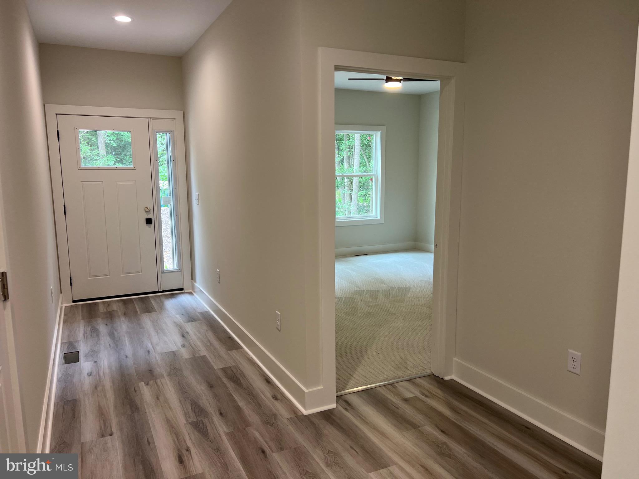 175 Rose Way Colonial Beach, VA 22443 - Photo 7 of 33 an empty room with wooden floor and windows