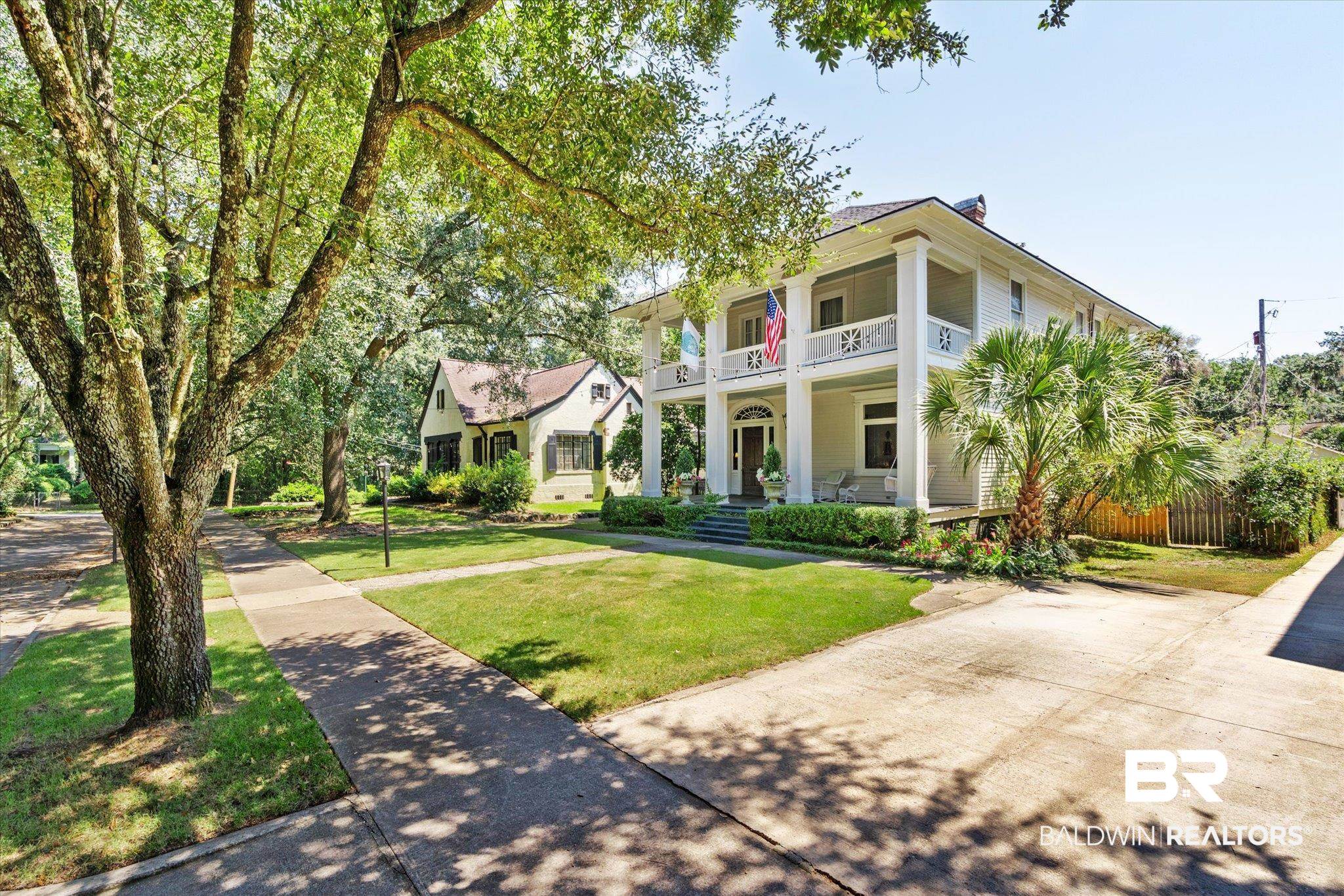 68 North Monterey Street Mobile, AL 36604 - Photo 30 of 30 Greek revival house with a front lawn, a porch, and a balcony