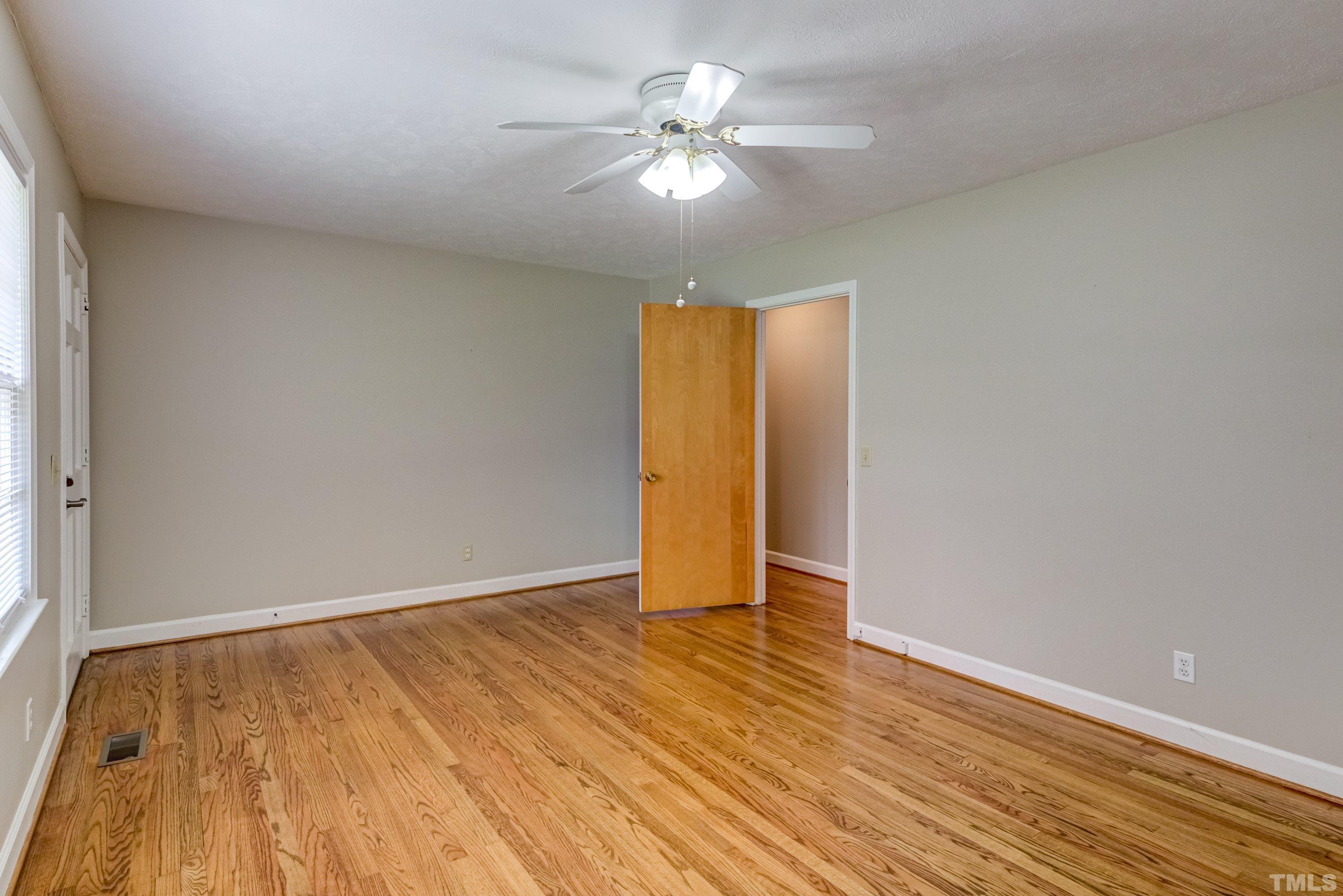 128 Spring Lane Lillington, NC 27546 - Photo 12 of 42 wooden floor in an empty room with a window